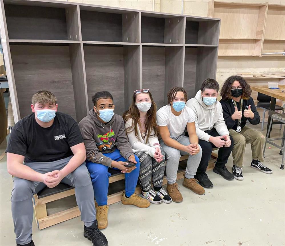 Tech Ed students posing with the prototype lockers they built